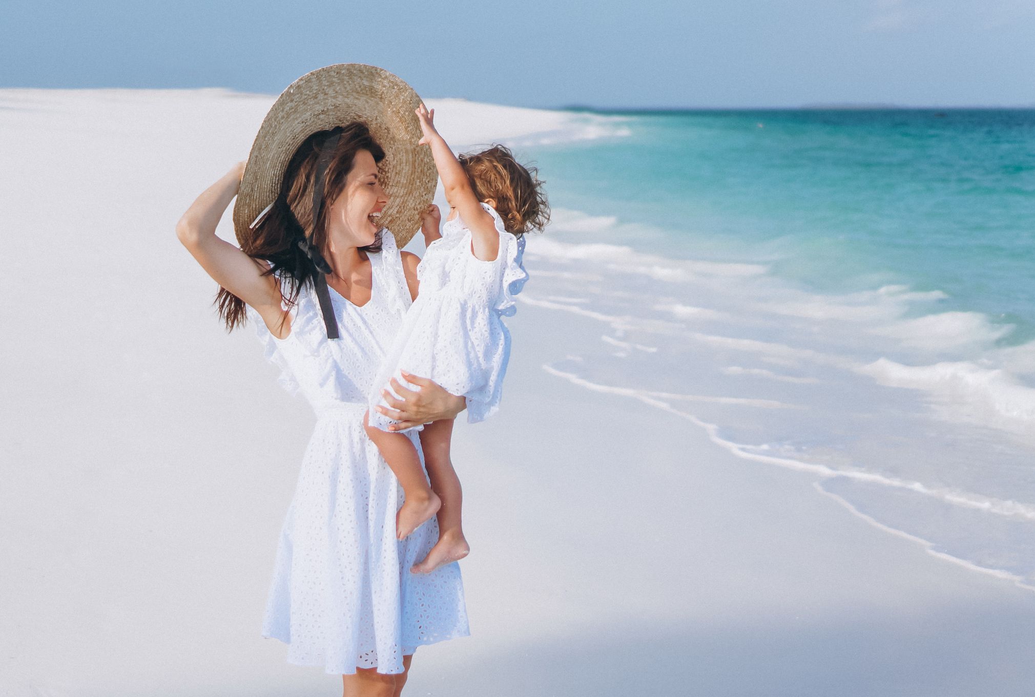 young-mother-with-her-little-daughter-beach-by-ocean