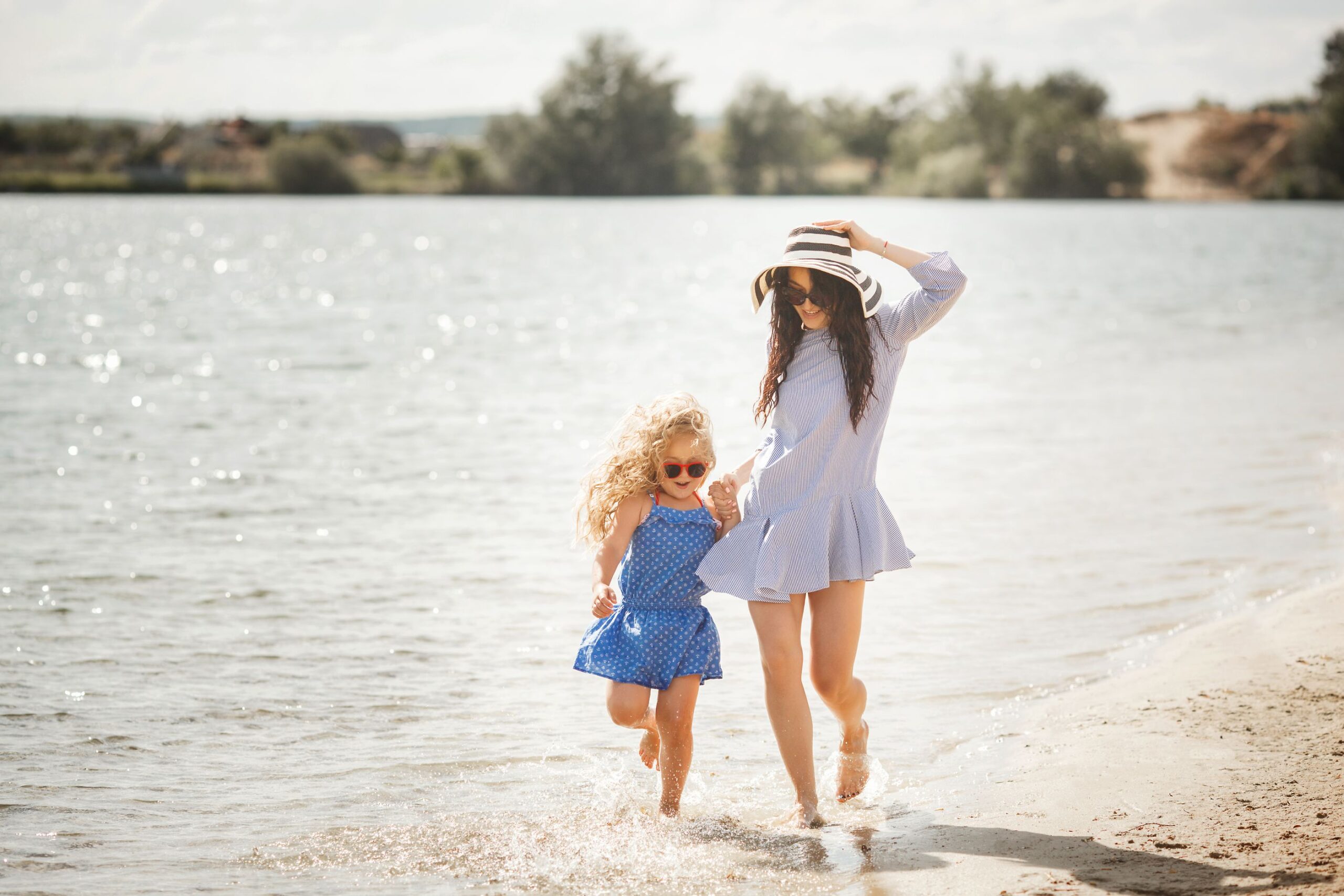 mother-her-little-daughter-having-fun-coast-young-pretty-mom-her-child-playing-near-water